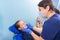 A female dentist doctor makes an inspection of a patient of a teenage girl in the clinic.