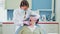 Female dentist doing dental treatment to elderly patient