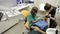 A female dentist and her assistant working on a patients teeth