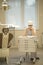 A female dentist in her medical office wearing a face mask fills out paperwork.