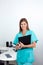 Female Dentist Holding Clipboard In Clinic