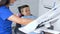 Female dentist with kid patient at dental clinic