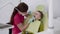 Female dentist making careful brushing child's teeth with dental tools in clinic