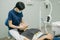 Female dentist in medical white latex gloves puts rubber dam on a patient in a dental clinic. Cleaning teeth. Modern