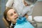 Female dentist puts on a guy patient a mouth guard a removable orthodontic teeth alignment