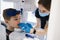 Female dentist taking panoramic teeth radiography to a little boy using modern x-ray machine