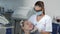 Female dentist uses dental tool to check patient\'s teeth