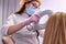 female dermatologist looking at a dermatoscope while examining female head and hair