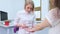 a female dermatologist using a medical magnifying glass in the clinic examines the patient\'s skin.