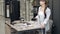 Female designer with phone at desk in tile showroom office