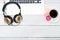 Female desktop. golden headphones, coffee cup, macaroons.