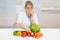 Female dietician examining vegetables