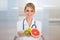 Female dietician holding fruits