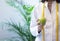 Female dietitian in apron and tape measure holding apple