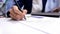 Female director signing document on office table, company agreement, business