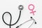 Female diseases concept. Stethoscope near female sign on white background top view