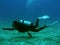 female dive master pointing underwater