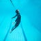 Female diver flying underwater