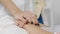 Female doctor calms, supports the patient prior to surgery. Woman doctor puts his hand on the palm of the patient