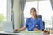 Female doctor chats online with patient Attractive female doctor working remotely from hospital in office