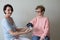 Female doctor checking blood pressure elderly woman