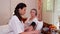 Female doctor checking blood pressure to senior woman