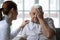 Female doctor comforting older man patient feeling unwell