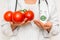 Female doctor compare pile of pills with fresh tomatoes