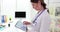Female doctor concentrates on reviewing schedule using tablet