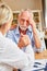 Female doctor consoles senior patient with depression