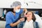 Female doctor cosmetologist performing machine facial procedure to mature woman in clinic