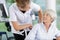 Female doctor with disabled senior patient in hospital