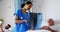 Female doctor discussing x-ray report with male senior patient in the ward