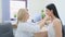 a female doctor examines the patient\'s throat in the office.