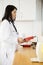 Female Doctor Examining Blood Sample In Machine At Hospital