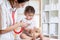 Female doctor examining child toddler with stethoscope