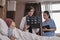 Female doctor explains x-ray film to patient at inpatient room bed in hospital