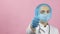 Female doctor in face mask and medical gloves showing hand gesture thumbs up