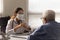 Female doctor in facial mask consult mature patient
