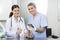 Female Doctor Giving Injection To Weasel Held By Nurse