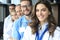 Female doctor with group of happy successful colleagues