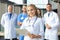 Female doctor with group of happy successful colleagues