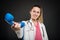 Female doctor handing big blue telephone receiver and smiling