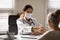 Female doctor handshake mature patient in hospital