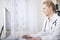 Female Doctor at her Desk Using her Computer