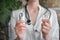 Female doctor hold various thermometers. People and healthcare concept. Coronavirus. Green leaves on background