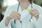 Female doctor holding bottle of dietary supplement