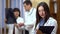 Female doctor holding a folder in his hands. In the background, the doctors checked the x-rays.