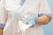 Female doctor holding a glasses and a respirator as protection against airborne viruses