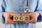 Female doctor holding letters OCD obsessive compulsive disorder abbreviation from wooden blocks